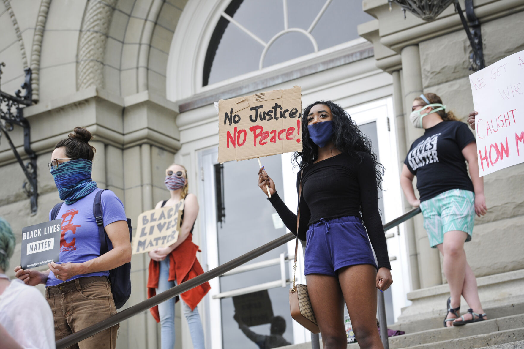 Protesters gather on the steps of the City-County Building Friday